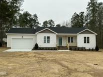 Charming single-story home featuring a two-car garage and a welcoming covered porch at 2242 Eldridge Rd, Newton Grove, NC 28366