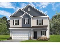Charming two-story home featuring a classic design and beautiful curb appeal with well-manicured lawn at 275 Deodora Ln, Cameron, NC 28326