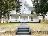 Inviting two-story home with a covered front porch and a stone pathway to the entrance at 347 W Trade St, Burlington, NC 27217