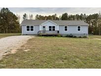 Charming one-story home with gray siding, front porch, and inviting curb appeal at 349 Tristen Ln, Henderson, NC 27537