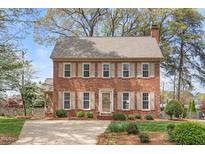 Charming brick two-story home with a well-manicured lawn and traditional shutters at 3529 Elk St, Burlington, NC 27215