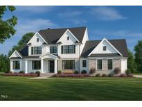 Stunning new construction home featuring a stone facade, white siding, and a well-manicured lawn at 4030 Granite Ridge Trl, Raleigh, NC 27616