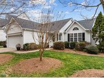 Charming home featuring manicured lawn, mature landscaping, and classic white siding at 409 Latta Cir, Durham, NC 27712