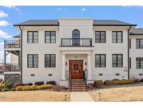 Stunning three-story building with a light brick exterior, black trim, and a welcoming entrance at 605 Smedes Pl # B, Raleigh, NC 27605
