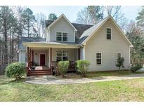 Charming home featuring a covered porch, well-maintained lawn and professional landscaping at 773 Rebecca Ln, Siler City, NC 27344