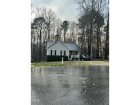 Charming one-story home with a cozy front porch and mature trees at 128 Madeline Ct, Youngsville, NC 27596