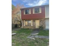 Inviting two-story townhome with brick and siding, complemented by a quaint front yard at 2408 Stadium Dr # A, Durham, NC 27704