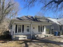 Charming cottage-style home with a covered front porch and dark shutters at 2711 Ashe St, Durham, NC 27703