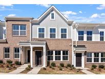 Charming brick townhomes with well-maintained landscaping and inviting front entrances offer curb appeal at 280 Chesapeake Commons St # 151, Garner, NC 27529
