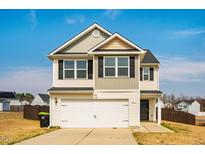 Two-story home featuring a two-car garage and neutral siding, complemented by black shutters and a well-maintained lawn at 314 Mason Trace, Burlington, NC 27217