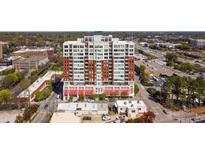 Stunning aerial view of a modern, multi-story building with red awnings and a bustling city skyline at 400 W North St # 804, Raleigh, NC 27603