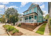 Inviting two-story home featuring a spacious front porch and classic architectural details at 101 N Bloodworth St, Raleigh, NC 27601