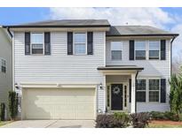 Charming two-story home with a light gray exterior, black shutters, a front-entry garage, and a welcoming front door at 1033 Leatherstone Ln, Fuquay Varina, NC 27526