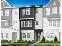 Modern townhome showcasing a dark and light siding and a manicured lawn at 1036 Zelkova Ln, Chapel Hill, NC 27517
