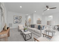 Bright living room featuring neutral tones, modern furniture, and stylish decor creating an inviting atmosphere at 116 Pointe Park Cir, Holly Springs, NC 27540