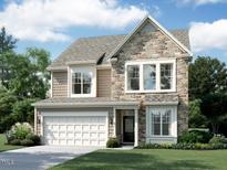 Charming two-story home featuring a stone facade, attached two-car garage, and a well-manicured front lawn at 1366 Sparkling Lake Dr # 79, Apex, NC 27523