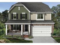 Charming two-story home featuring a stone facade, a covered porch, and an attached two-car garage at 1415 Sparkling Lake Dr # 60, Apex, NC 27523