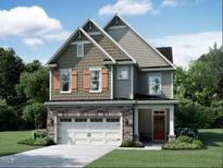 Charming two-story home with stone accents, a two-car garage, and a beautifully landscaped front yard at 1420 Sparkling Lake Dr # 67, Apex, NC 27523