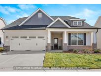 Charming single-Gathering home featuring a two-car garage, welcoming front porch, and attractive landscaping at 1811 Parham Dr, Graham, NC 27253