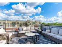 Relaxing rooftop deck featuring comfortable seating and a stylish outdoor rug with scenic neighborhood views at 2000 Moody Ln, Durham, NC 27701