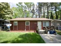 Charming one-story home with wood siding, a well-manicured lawn, and a welcoming front entrance at 2726 Thelma St, Durham, NC 27704