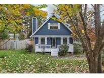 Charming blue two-story home with a cozy front porch and a well-manicured, inviting lawn at 3746 Guess Rd, Durham, NC 27705