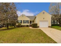 Charming single-Gathering home with attached garage, manicured lawn, and traditional architecture at 4212 Birmingham Way, Raleigh, NC 27604