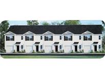 Charming townhomes with white exteriors, black roofs, and individual garages, providing a modern and stylish look at 521 Fife Ct, Gibsonville, NC 27249
