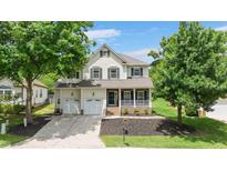Charming two-story home with green shutters, front porch, two-car garage, and well-manicured landscaping at 1106 Bellenden Dr, Durham, NC 27713