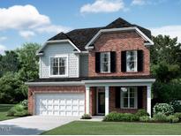 Charming two-story home with a brick facade, black shutters, a well-manicured lawn, and a two car garage at 1378 Sparkling Lake Dr # 76, Apex, NC 27523