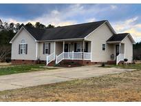 Charming single-story home with a cozy front porch, lovely curb appeal and neutral siding at 1925 Eagle View Drive Dr, Wendell, NC 27591