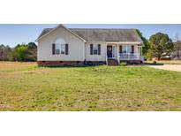 Charming single-Gathering home featuring a quaint front porch and well-maintained lawn at 1925 Eagle View Drive Dr, Wendell, NC 27591