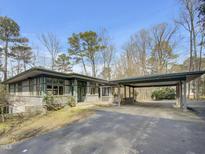 Unique contemporary home with a covered parking area and mature landscaping at 2916 Neuse Rock Trl, Wake Forest, NC 27587