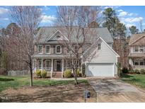 Charming two-story brick and siding home with a well-maintained lawn and two car garage at 3 Rencher Ct, Durham, NC 27703