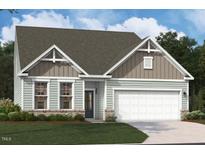 Charming single-story home featuring stone accents, neutral siding, a two-car garage and well-manicured lawn at 3232 Shannon Woods Lane # 12, Apex, NC 27523