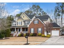 Charming two-story home featuring a welcoming front porch, well-maintained lawn, and attached garage at 3659 Coach Lantern Ave, Wake Forest, NC 27587
