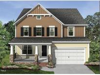 Charming two-story home featuring a welcoming front porch and an attached two-car garage at 5022 Aged Pine Rd # 49, Apex, NC 27523