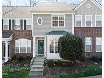 Charming townhome with a welcoming green front door and manicured landscaping at 5333 Crescentview Pkwy, Raleigh, NC 27606