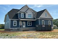 New home with blue siding, white trim, and a dark roof, showcasing modern design and construction at 70 Prency Ln, Middlesex, NC 27557