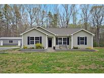 Charming single-story home with black shutters and a landscaped front yard at 765 Townsville Landing Rd, Henderson, NC 27537