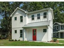 Charming two-story home with white siding, bright red door, and lush green lawn at 802 Pleasant Dr, Durham, NC 27703