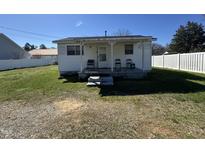 Cozy home with a quaint front porch and seating, perfect for relaxing outdoors at 113 Smith St, Four Oaks, NC 27524