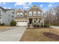 Charming two-story home with a welcoming front porch and attached two car garage at 1800 Bodwin Ln, Apex, NC 27502
