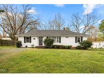 Charming one-story home features a well-maintained lawn and classic white siding at 1870 Prince Edward Dr, Elon, NC 27244