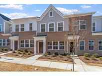 Beautiful brick townhome with multiple windows and landscaping in a well-maintained community at 256 Chesapeake Commons St # 157, Garner, NC 27529