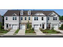 Attractive townhome exteriors featuring varying neutral colors and a one-car garage at 268 Hank Way, Angier, NC 27501