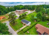 Aerial view of property with mature trees and a well-maintained lawn near the fire station and neighborhood at 3132 Fields Dr, Raleigh, NC 27603