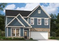 Charming two-story home featuring blue siding, brick accents, and a two-car garage. Well manicured lawn at 3201 Shannon Woods Lane # 19, Apex, NC 27523
