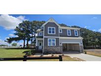 Beautiful two-story home with stone accents and a spacious two-car garage at 33 White Azalea Way, Homesite 80, Benson, NC 27504