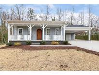 Beautiful light blue home featuring a covered porch and convenient side carport at 3650 Durwood Ln, Raleigh, NC 27604